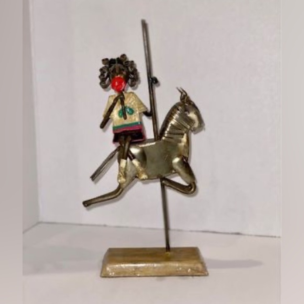 Metal Sculpture of girl on a horse carousel with lollipop by Arte Felguerez
